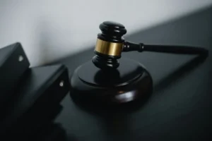 Judge's gavel on a dark wooden surface in a courtroom