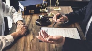 Slip And Fall Lawyer Reviewing Injury Claim With Client
