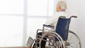 Elderly Nursing Home Resident Sitting Alone In Wheelchair