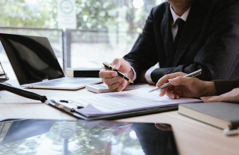 Illinois Personal Injury Lawyer Reviewing Legal Documents With Client