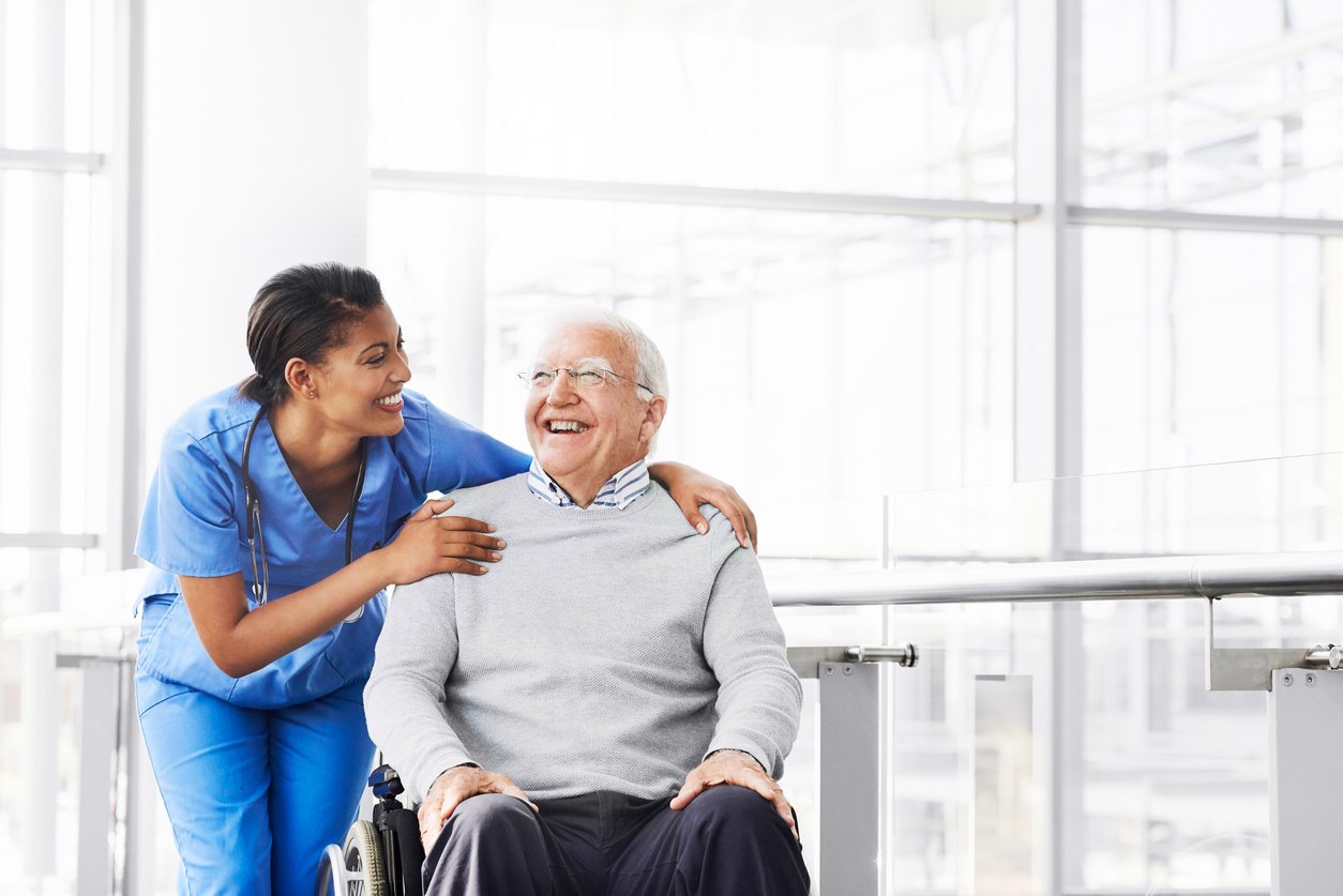 She loves seeing her patient’s happy Nurse assisting an elderly nursing home resident in a wheelchair